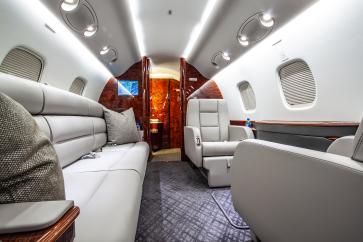 N529GB Legacy 600 AFT Cabin featuring a three-seat divan that can be converted into a full size bed.