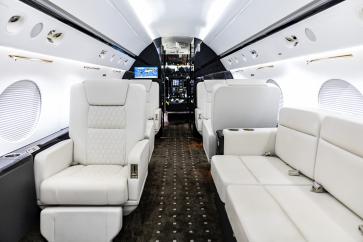Three-passenger divan can be converted into a full size bed for long flights.